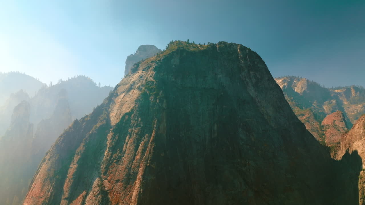 Rising up along a huge mountain at sunny clear daytime. Rocks of amazing Yosemite National Park, California, USA. Low angle view.