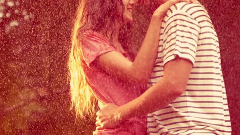 Happy-couple-hugging-in-the-park-during-rain
