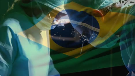 animation of flag of brasil waving over surgeons in operating theatre