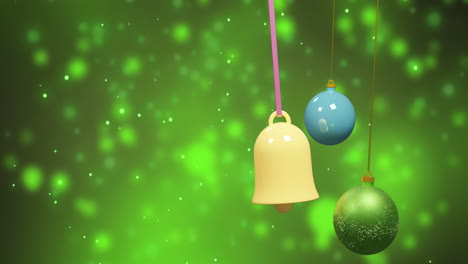 animation of christmas baubles over snow falling on green background