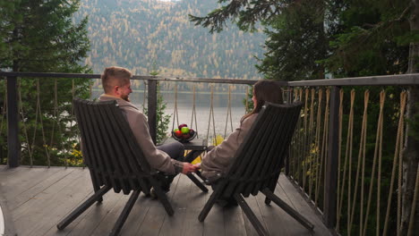 couple enjoying autumn scenic view from cabin patio