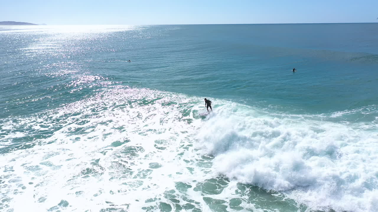 4k Drone shot of a man surfing on a large ocean wave on his surfboard and having fun in Australian.