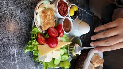 breakfast platter with cheese, tomatoes, pastry, and egg