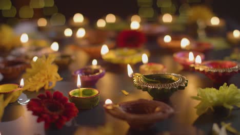 Close-Up-Shot-Of-Diya-Oil-Lamps-Celebrating-Festival-Of-Diwali-Burning-In-The-Dark-1