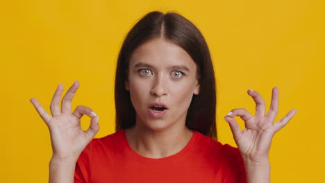 woman with a surprised expression and ok hand gesture
