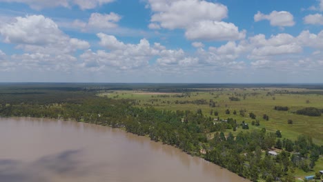 drone captures vast rural scenery with river and farms