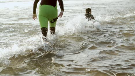 mother helping son swimming on board