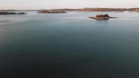 aerial shot of a lake in cohasset during the day - 4k