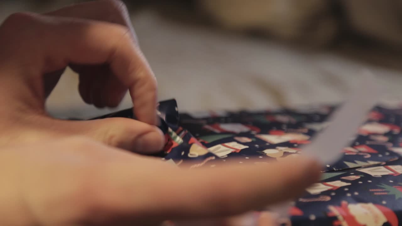 Folding The Edge Of A Gift Wrap And Closing It With A Scotch Tape - Close Up Shot