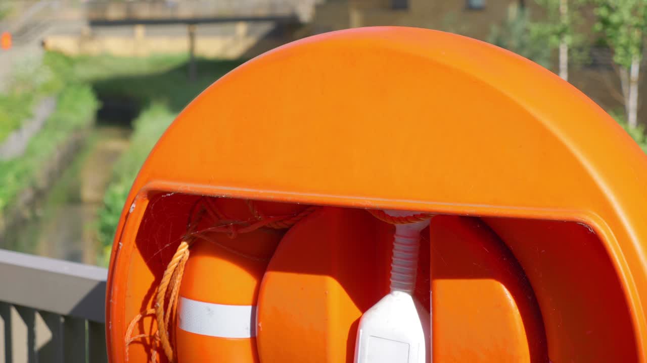 Lifebuoy near the lake in the city in 4k slow motion 60fps