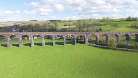 reveal drone footage of welland viaduct northamptonshire, also known as the harringworth and seaton viaduct over river welland and valley on sunny day