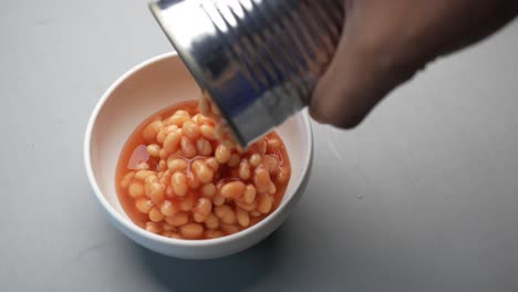 preserved canned tomato beans pouring into a bowl