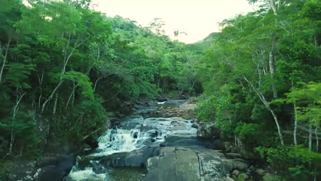 Breathtaking-long-aerial-shot-of-waterfall-in-Brazilian-rainforest-in-summer,-perfect-green-nature