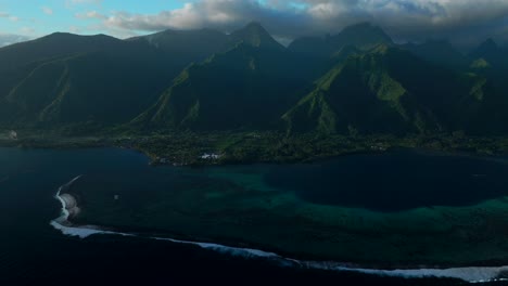 Last-light-sunset-on-towering-mountain-peaks-surf-reef-break-channel-Teahupoo-Wave-Tahiti-French-Polynesia-aerial-drone-view-incredible-stunning-island-landscape-Moorea-Bora-Bora-Papeete-backwards-pan