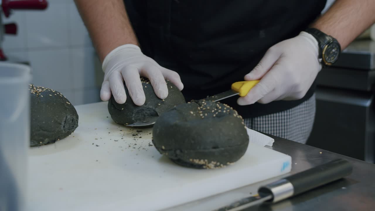 A professional chef is preparing a hamburger in his kitchen - 05