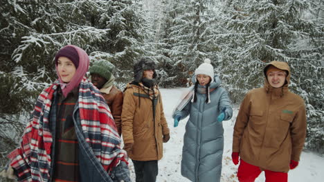 friends walking in winter forest