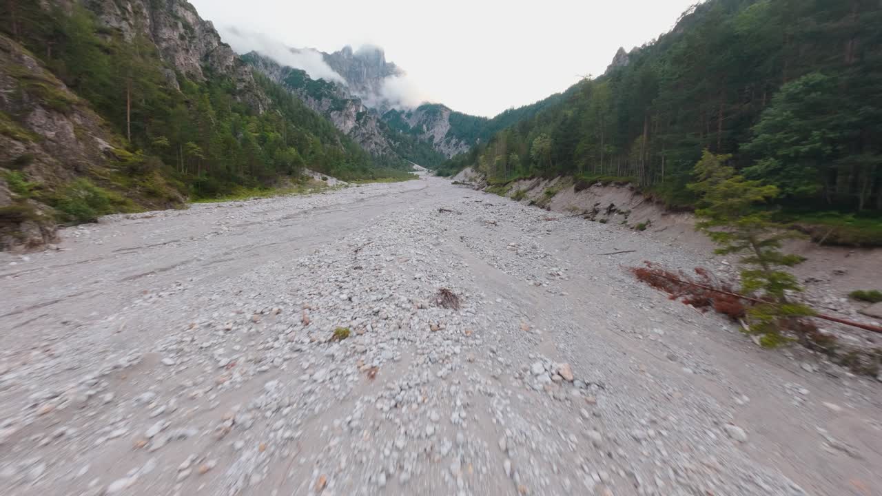 Aerial first person view of limestone river valley in Gesäuse, dry riverbed