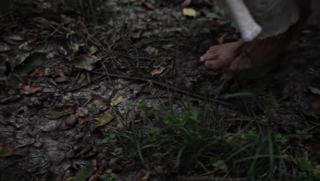barefoot person walking on a dirt path