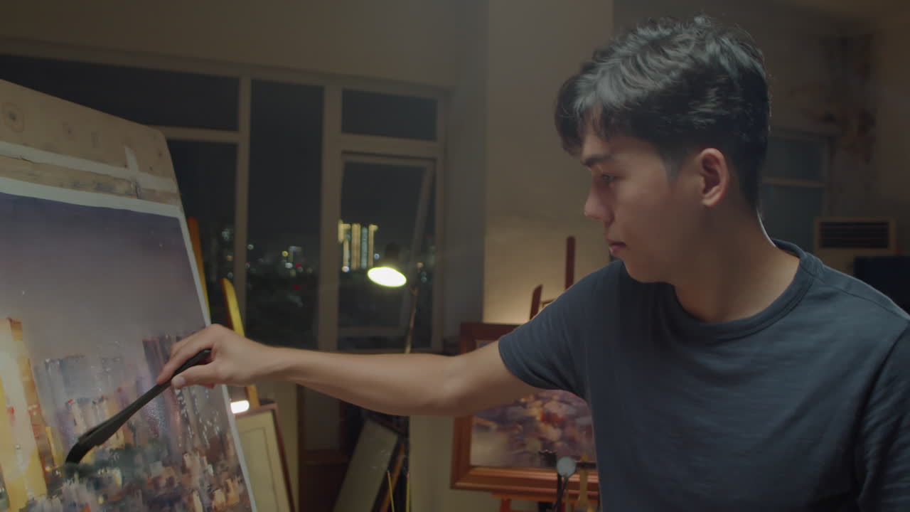 Asian Man Drawing Night Cityscape on Canvas