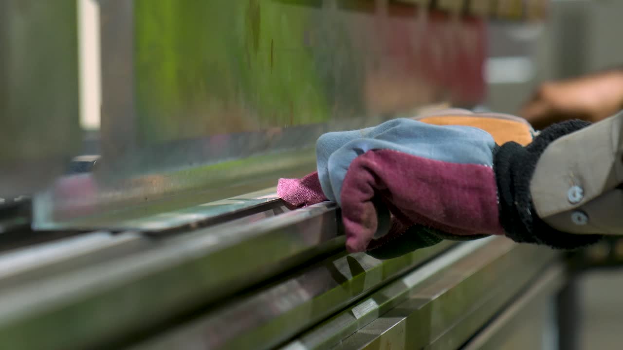 Worker Operating A Hydraulic Press Brake, Bending Metal In A Industrial Metalworking Factory. Close Up Shot