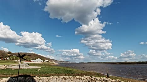 Mississippi-River-in-Grafton,-Illinois-with-Panning-Shot-Viewing-the-Great-River-Road-Bluffs-on-a-Sunny-Day,-USA