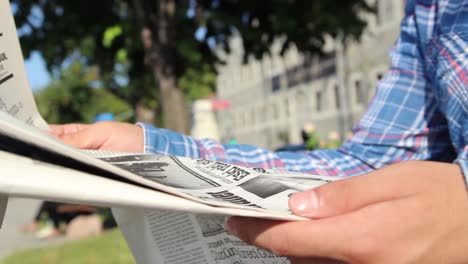 young reading newspaper