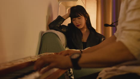 a pianist playing a piano for a woman