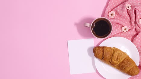 romantic arrangement with fresh croissant and cup of coffee move next to paper card note. stop motion