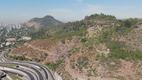 Aerial-View-Of-Hillside-Beside-Highway-Junction-Roads-Near-Bicentenario-Park-In-Santiago