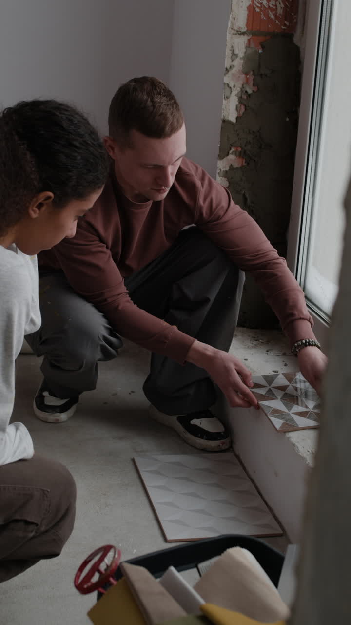 Couple Working Together on Home Renovation Project: Tile Installation