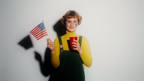 young woman celebrating election day with american flag and red cup