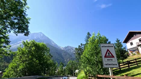 mountain road with signs and houses