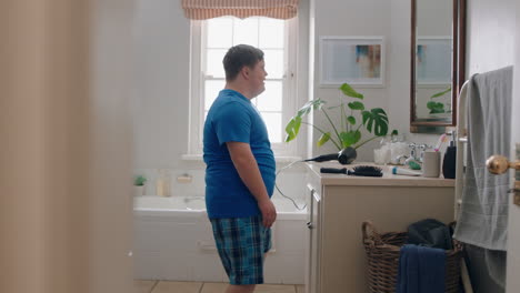 funny-teenage-boy-with-down-syndrome-dancing-in-bathroom-having-fun-doing-silly-dance-moves-enjoying-morning-routine-feeling-happy-at-home