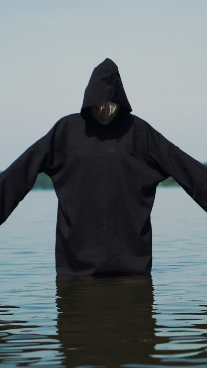 Terrible witch on the river bank. Mysticism of Halloween Vertical video