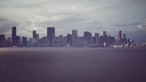 a view of a city skyline over a calm waterfront during cloudy weather