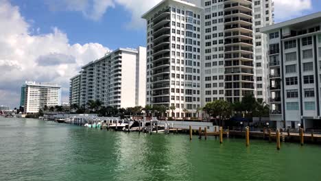 moving shot going through the waterways of miami with nice homes and high rises