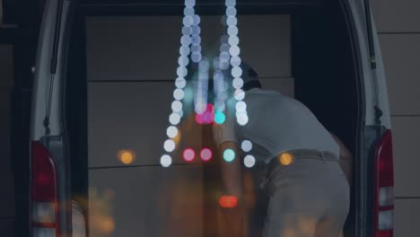 animation of road at night over caucasian male deliverer with cartons