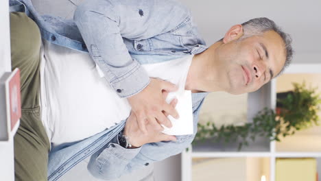 Vertical-video-of-The-afflicted-man.-The-man-is-looking-at-the-photo-and-kissing-it.