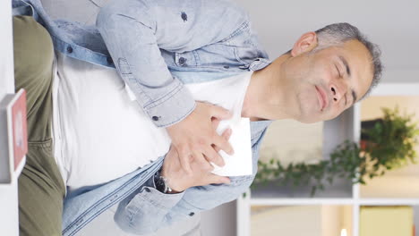 vertical video of the afflicted man. the man is looking at the photo and kissing it.