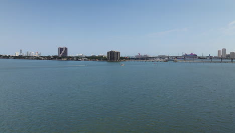 aerial view approaching a motorboat driving on the coast of sunny miami, florida