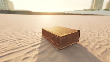 old-book-on-the-sand-beach