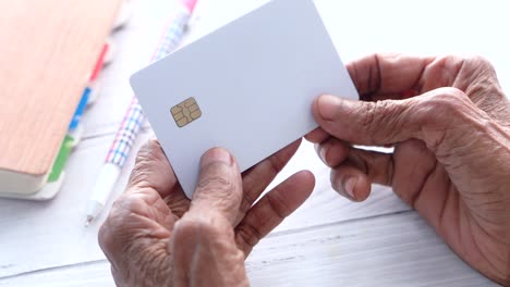 elderly person holding a credit card