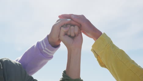 diverse group of female friends teaming up at the beach