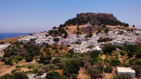 beautiful aerial view of lindos te rhodes greece with its clifftop acropolis above the white houses on the mountaintop