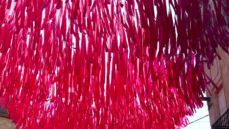 colorful ribbons sway above a street