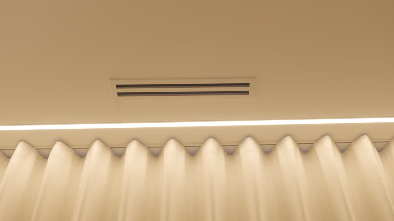Slow establishing shot of electronic curtains and air conditioning panels
