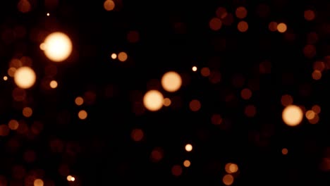 partículas de movimiento lento luces bokeh en fondo negro. fondo imágenes 4k partículas de oro fondo