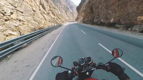 pov of riding motor bike on dangerous cliff hanger himalayan roads of kinnaur valley in himachal pradesh india