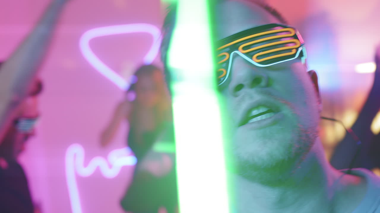 Man in Neon Sunglasses Partying Enthusiastically