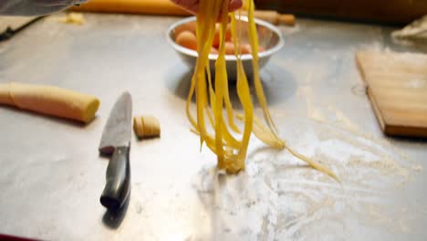 Male-and-female-baker-preparing-pasta-4k